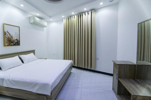 Ένα ή περισσότερα κρεβάτια σε δωμάτιο στο Exclusive Muscat Homes Hotel Apartments