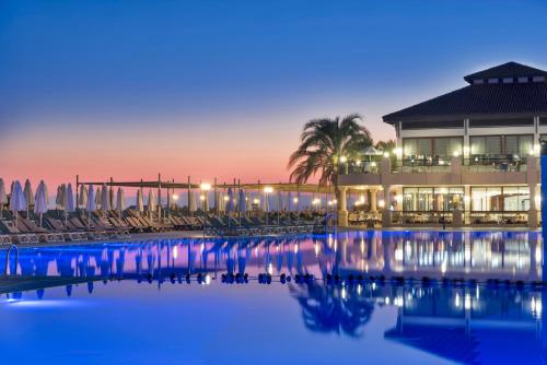 a resort with chairs and a pool at dusk at Club Nena - All Inclusive in Kizilagac