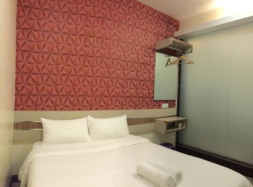 Ένα ή περισσότερα κρεβάτια σε δωμάτιο στο Hotel Alor Gajah
