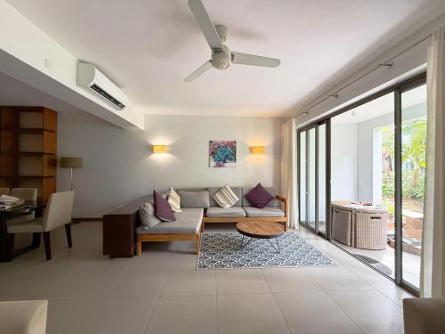 a living room with a couch and a ceiling fan at La Residence with LOV in Midlands Station