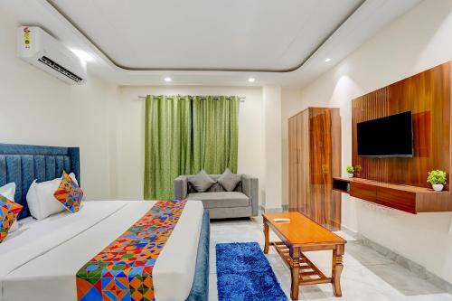 a hotel room with a bed and a tv at FabHotel The Royal Kishan Complex in Noida