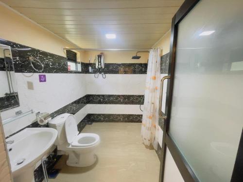 a bathroom with a toilet and a sink at Beach Cabanas Hiriketiya in Hiriketiya