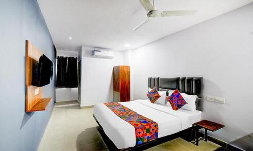 a bedroom with a large bed in a room at FabHotel Lorwen in Hyderabad