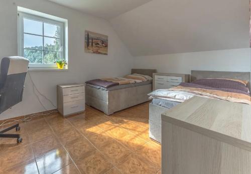 Postel nebo postele na pokoji v ubytování V Bukách