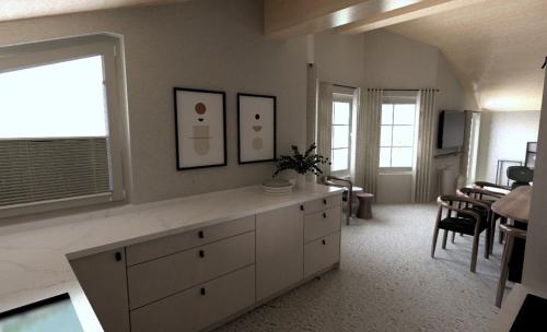 a living room with a counter and a dining room at fuchs am meer in Mitterhofen