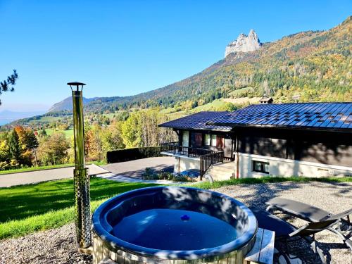 a large blue tub sitting on top of a yard at Venez chez vous - Chalet le Dahu in Rovagny