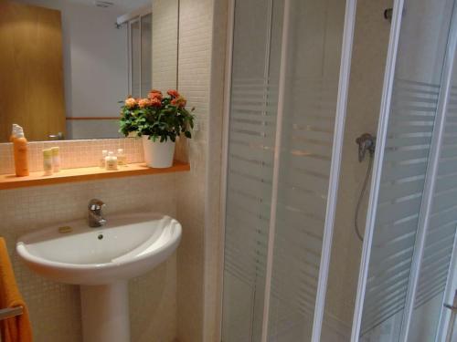 a bathroom with a white sink and a shower at Apartment Sun & Beach in Platja d'Aro in Platja d'Aro