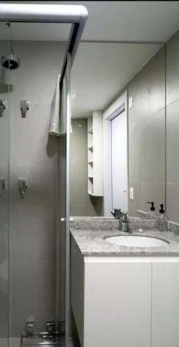a bathroom with a sink and a mirror at Studio Lumiere in Sao Paulo