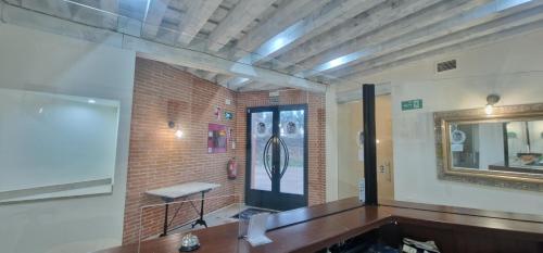 a room with a mirror and a brick wall at Hotel Rural Atalaya in Guadalupe