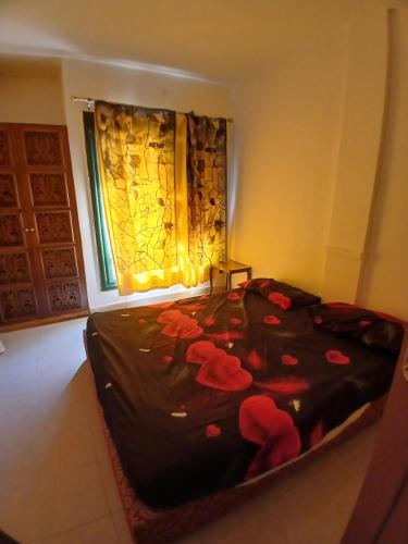 a bedroom with a bed with red flowers on it at Criss Naama bay in Sharm El Sheikh