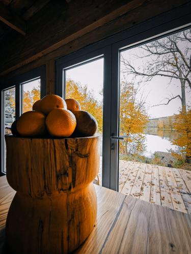 a bowl of fruit sitting on a table in front of a window at Lubie Domek in Nowa Wioska