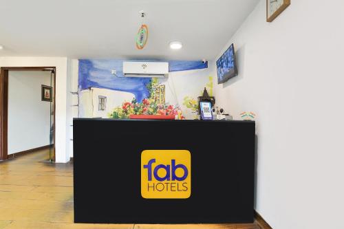 a table with a sign on it in a room at FabHotel Crescent in Faridabad