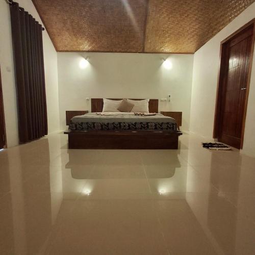 a bedroom with a bed in the middle of a room at wide view house in Kuta Lombok