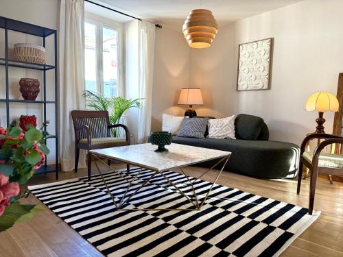 a living room with a couch and a table at Savigny les Beaune city center in Savigny-lès-Beaune
