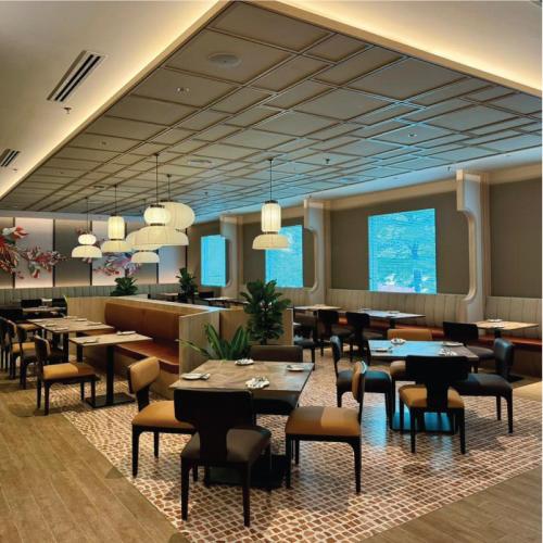 a restaurant with tables and chairs in a room at Grand Mercure Kuala Lumpur Bukit Bintang in Kuala Lumpur