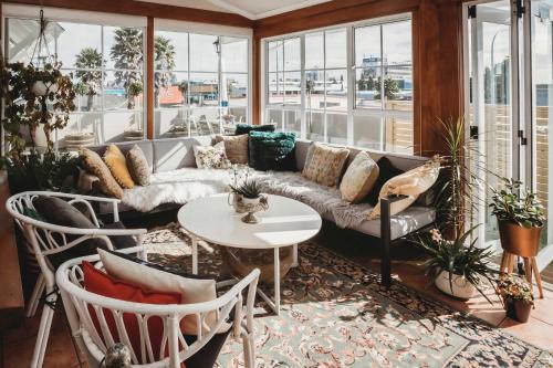 a living room with a couch and a table at Timata Ora - 7BR family home in prime location in New Plymouth