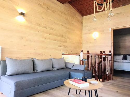 a living room with a blue couch and a table at G&J Traditional House in Elati Trikalon