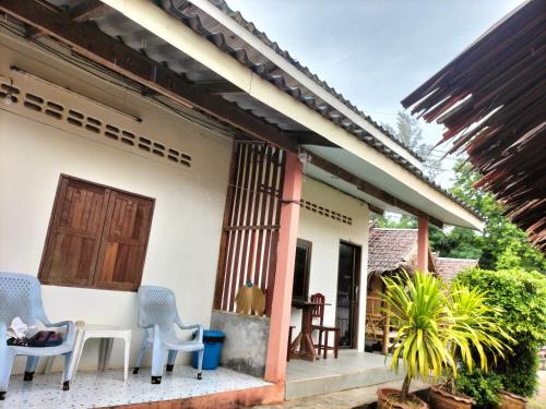 a house with two chairs and a table on a porch at Lanta Rabbit Rooms in Ko Lanta