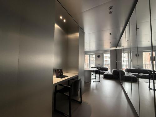 a room with a table and chairs in a building at Modern Chromo Design Apartment Center Kortrijk in Kortrijk