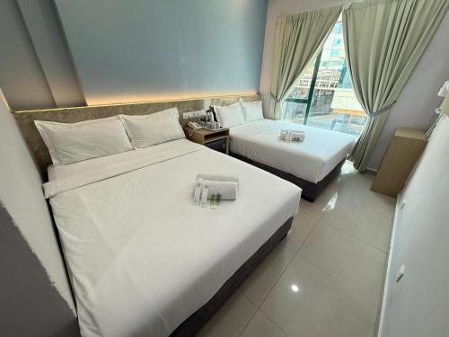 Postel nebo postele na pokoji v ubytování AQ Hotel