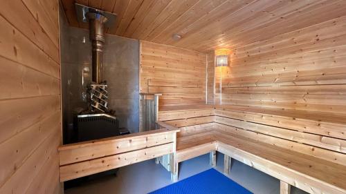a wooden sauna with a wood paneled wall at Set Sail Hotel in Uralsk