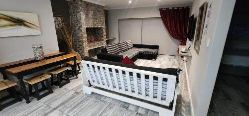 a living room with a crib and a piano at Bliss at Diaz in Mossel Bay