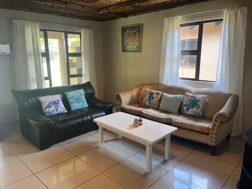a living room with a couch and a coffee table at Ufudu Chalet in Mbazwana