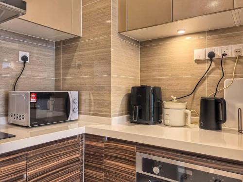 a kitchen with a microwave and coffee makers on a counter at R&F Princess Cove 2BR Sea View JB-SG Spacious in Johor Bahru