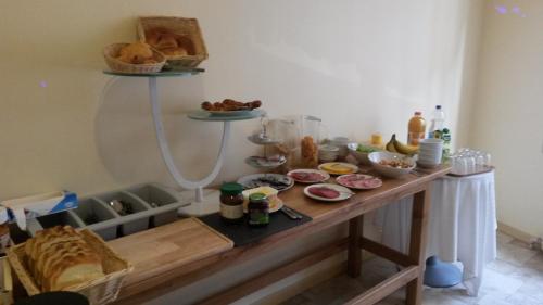 a table with a bunch of food on it at Hotel Queen Mary in Brussels