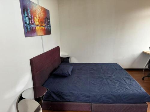 a small bedroom with a bed and a couch at JM House Kuala Lumpur in Puchong