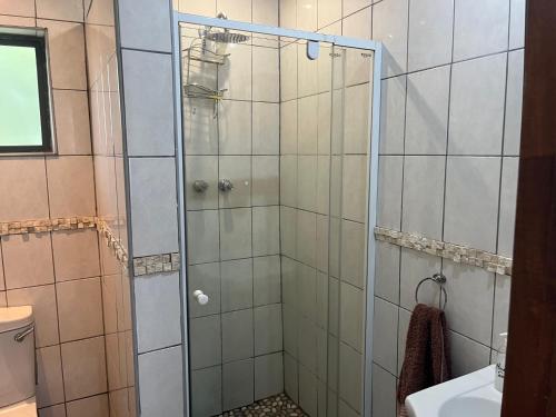 a shower with a glass door in a bathroom at Ingwenya Chalet in Sodwana Bay