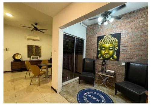 a living room with a painting of a head on the wall at JM House Kuala Lumpur in Puchong