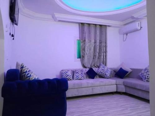 a living room with a couch and a window at Villa des deux frères in Midoun