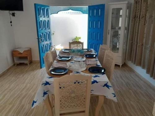 a dining room table with a table cloth with blue stars on it at Villa des deux frères in Midoun