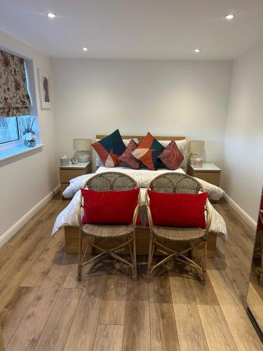 a bedroom with a bed with red pillows at Glastonbury Vista in Glastonbury