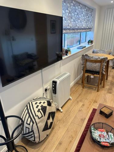 a living room with a radiator and a table at Glastonbury Vista in Glastonbury