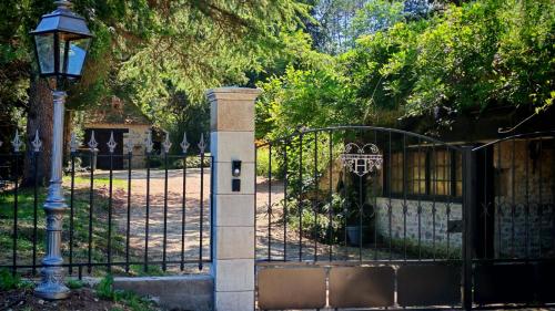 a gate with a stone pillar next to a fence at Bonfarto Locations in Urval