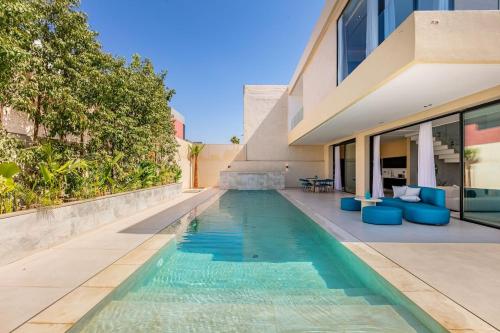 a swimming pool in the backyard of a house at Luxury Villa, Design, Comfort, Heated Pool, Games in Marrakech