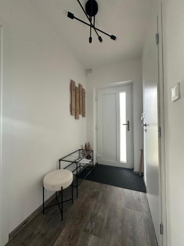 a room with a table and a chair and a door at Relax House Mšené-lázně in Loucká