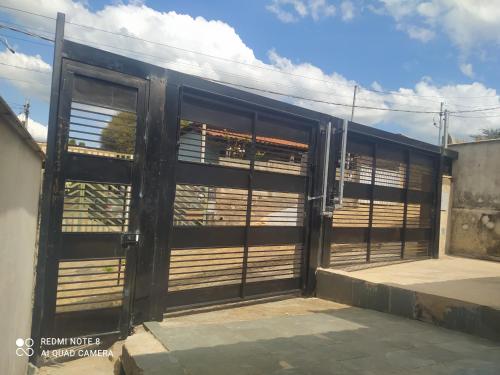 an open door of a building with wooden shutters at Hospedagem Altas da Quitéria Suíte 01 in Catas Altas