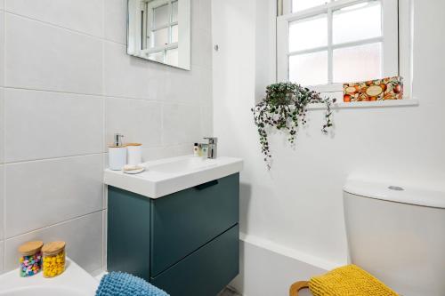 a bathroom with a sink and a toilet at Welcome London Theatreland House in London
