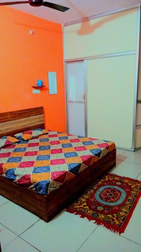a bedroom with a bed and a rug on the floor at Stacy Guest House in Jīnd