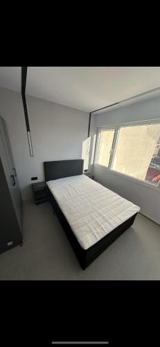 a bed in a room with a large window at Lux Central Apartment in Kilkís