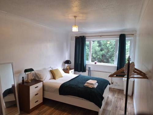 a bedroom with a bed and a window at Greensfield Lodge in Hartford