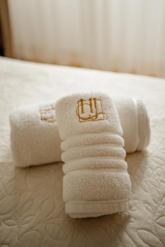 a pile of towels sitting on top of a bed at Hotel Jeruzalem in Ljutomer