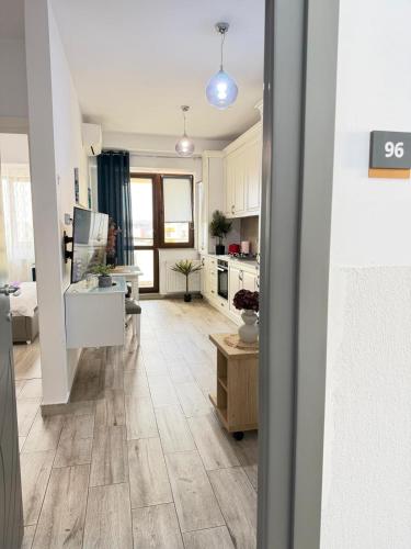 a living room with a kitchen and a dining room at Studios Palas by GLAM Center Area and Mall - Parking Option in Iaşi