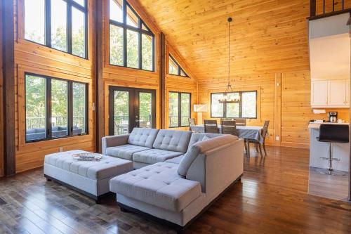 a living room with a couch and a table at Lakefront - Spa - Pool table - Mistral 154 in Sainte-Marguerite