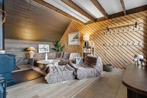 a living room with a couch and a table at Spa & Nature view - Alpenglow in Sainte-Germaine-du-Lac-Etchemin