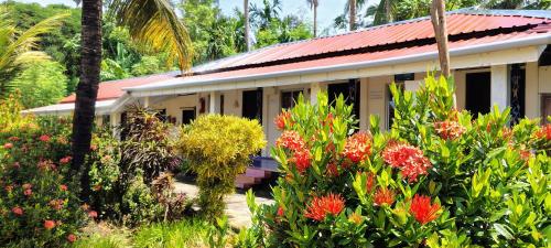 a building with a lot of flowers in front of it at Blue Bird Residency in Neil Island