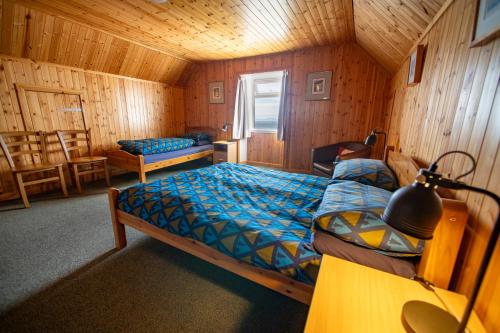 a bedroom with a bed in a wooden cabin at Gairloch Sands Youth Hostel in Gairloch